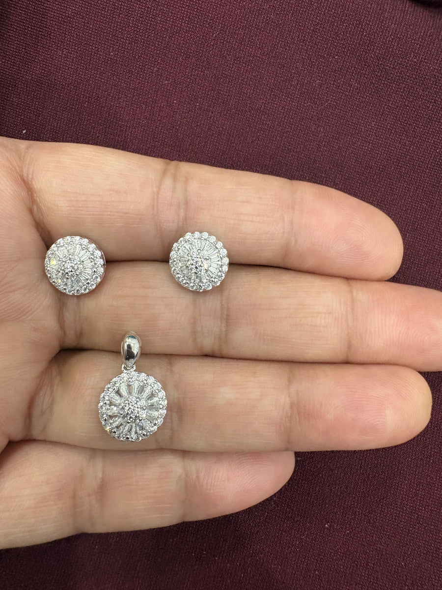 Floral sunburst pendant and matching stud earrings with sparkling clear stones