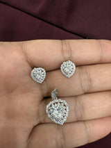 Heart-shaped pendant and matching stud earrings with a sparkling halo design, chain not included.