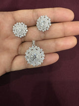 Round cluster halo pendant and matching earrings with clear sparkling stones