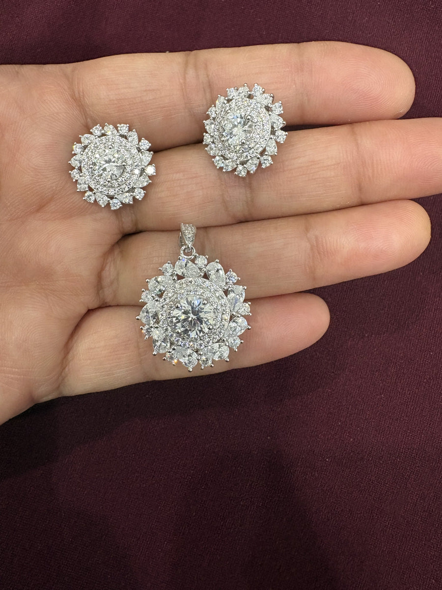 Round cluster halo pendant and matching earrings with clear sparkling stones