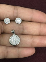 Round textured disc pendant and matching earrings set with polished rims, chain not included.