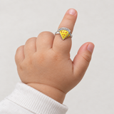 Yellow Triangle Kids Ring, worn on a one-year-old baby's index finger